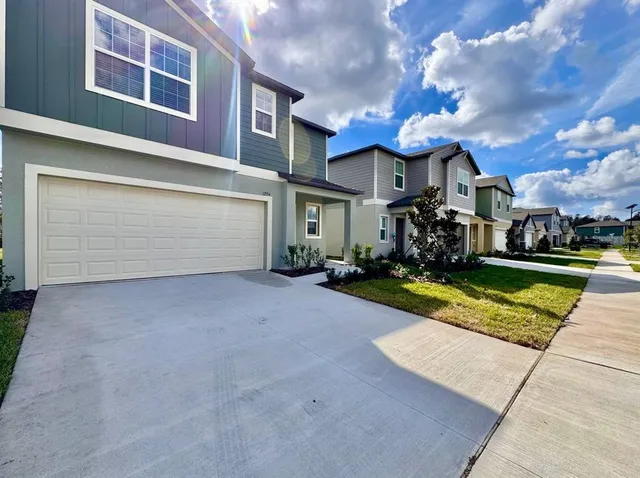 a view of a house with a swimming pool and a yard