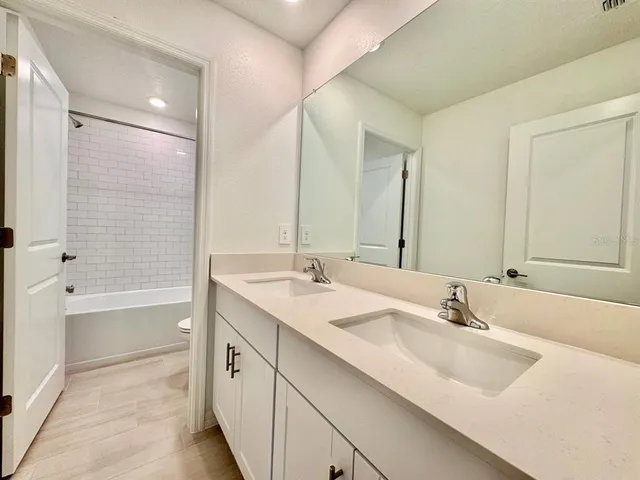 a view of an empty room with closet and a window