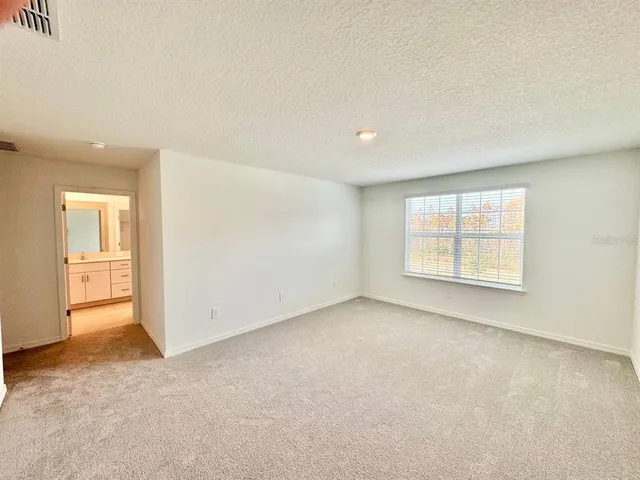 a spacious bathroom with a double vanity sink and mirror