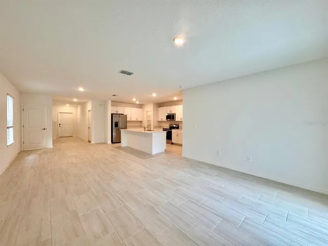 a view of kitchen and hall with wooden floor