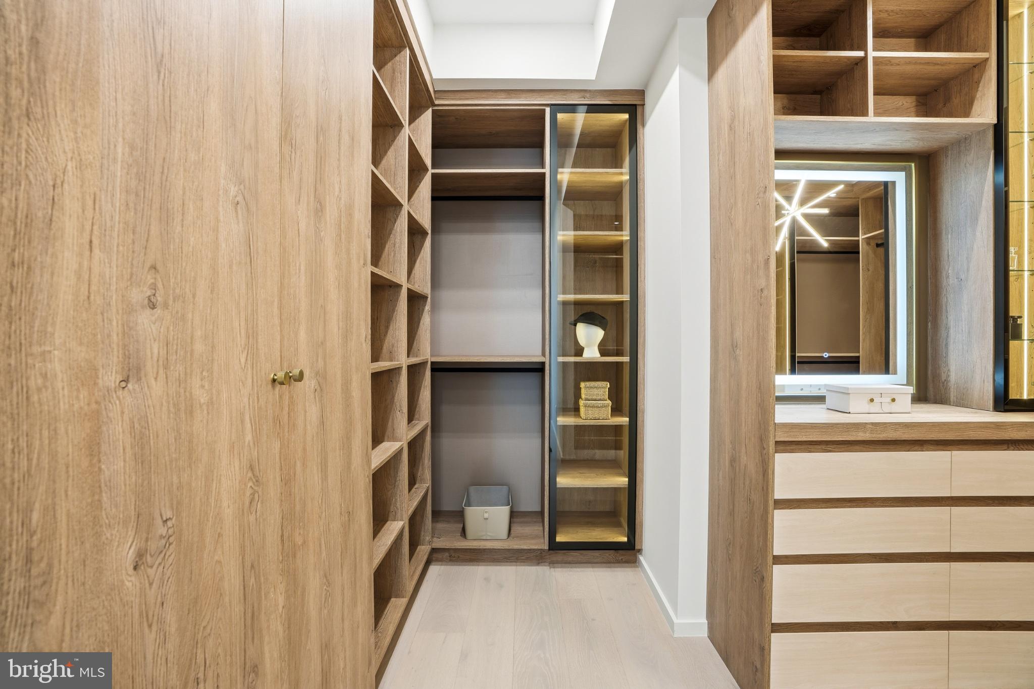 9408 Old Courthouse Road Vienna, VA 22182 - Photo 49 of 92 Sleek modern closet with elegant wood accents.