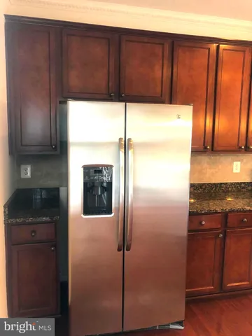 a kitchen with a refrigerator and cabinets