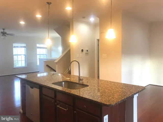 a white toilet sitting next to a white wall