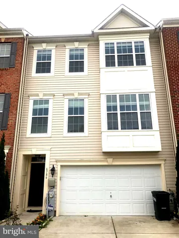 a front view of a house with a parking area