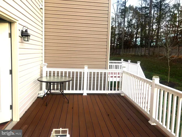 a view of a house with a wooden deck
