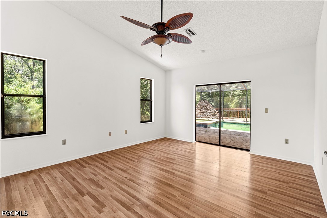 27255 Hickory Hill Road Brooksville, FL 34602 - Photo 33 of 50 wooden floor in an empty room with a window