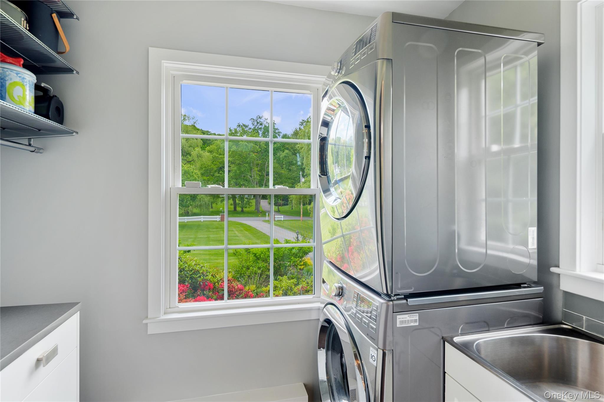 16 Fox Den Road Mount Kisco, NY 10549 - Photo 28 of 44 Windowed main level laundry room with LG washer and dryer, storage cabinetry, SS utility sink, folding counter, open shelves and hanging rod-conveniently located off of eat-in kitchen