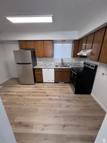 556 North Fairfield Road, Unit D4 Layton, UT 84041 - Photo 19 of 23 Kitchen featuring light countertops, freestanding refrigerator, electric range oven, light wood finished floors, and white dishwasher