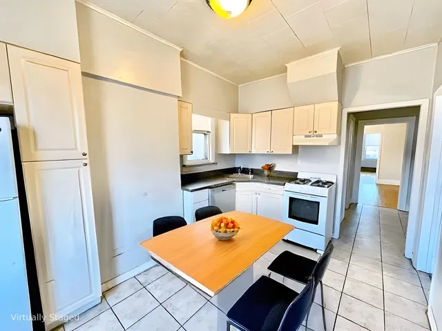 a kitchen with stainless steel appliances a refrigerator sink and cabinets