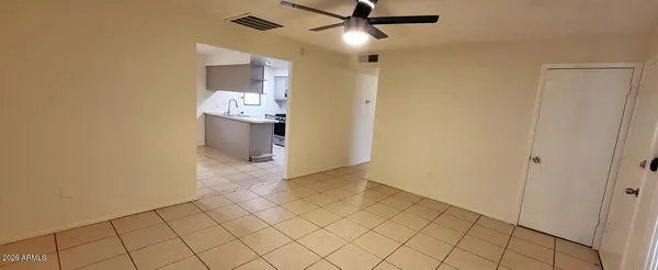 a view of a hallway to the room and a window