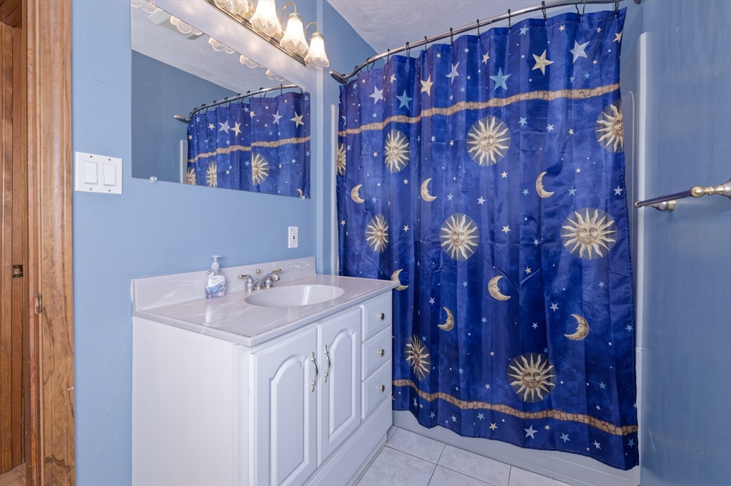 51 Brandon Road Dudley, MA 01571 - Photo 23 of 42 a bathroom with a sink and a mirror