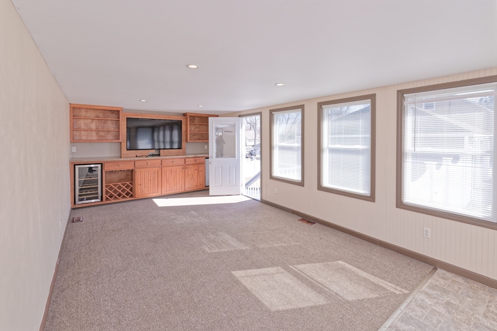 51 Brandon Road Dudley, MA 01571 - Photo 4 of 42 a big room with windows and a kitchen
