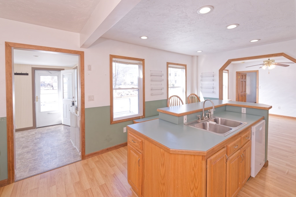 51 Brandon Road Dudley, MA 01571 - Photo 8 of 42 a very nice looking open kitchen with granite countertop a sink and dishwasher with wooden floor