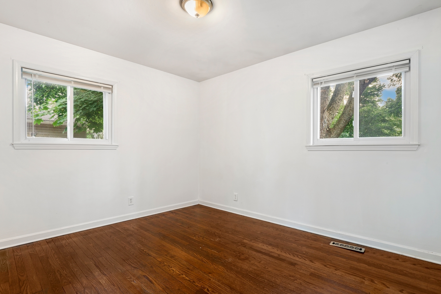 231 West 35th Street Steger, IL 60475 - Photo 11 of 17 an empty room with wooden floor and windows