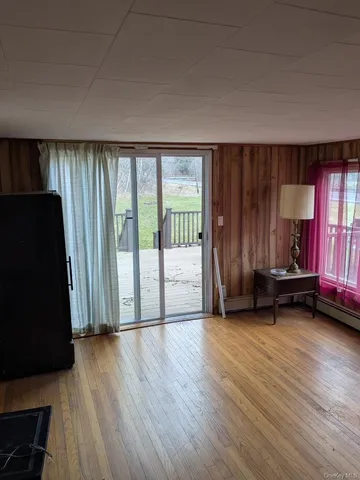 a view of a room with wooden floor and furniture