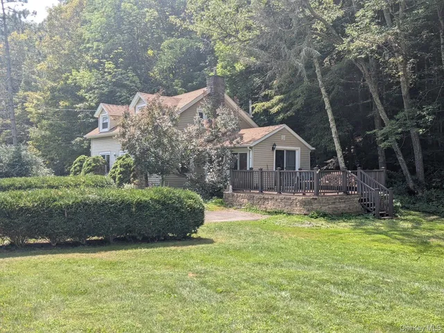 a front view of a house with a garden and yard