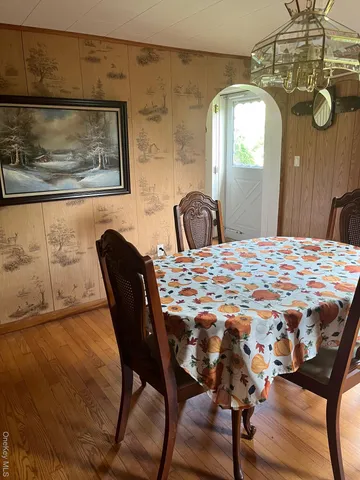 a view of a dining room with furniture and chandelier