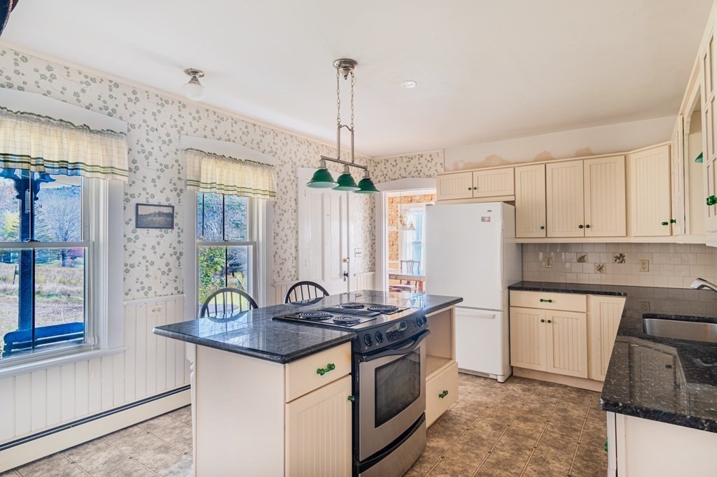16 Hazelton Road Rowe, MA 01367 - Photo 15 of 33 a kitchen with granite countertop a sink cabinets and stainless steel appliances