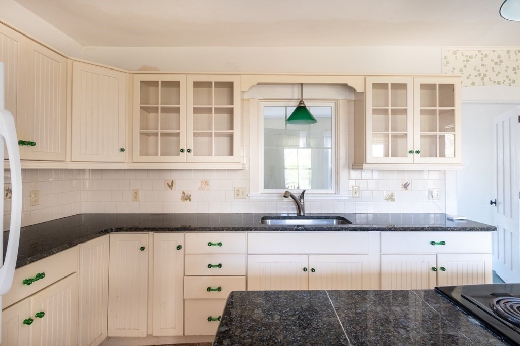 16 Hazelton Road Rowe, MA 01367 - Photo 16 of 33 a kitchen with granite countertop white cabinets and sink