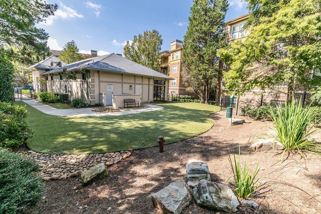 1401 West Paces Ferry Road Northwest, Unit 1303 Atlanta, GA 30327 - Photo 23 of 33 a view of a house with a yard