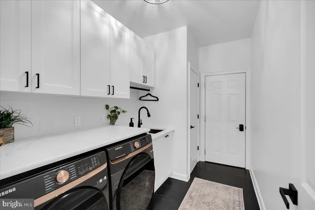 a spacious bathroom with double vanity and a mirror