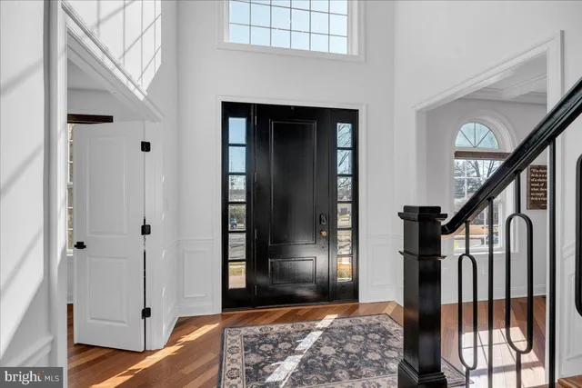 a living room with furniture and chandelier