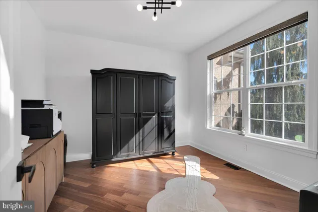 a bedroom with furniture and wooden floor
