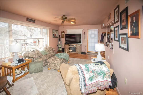 a living room with furniture large window and flat screen tv