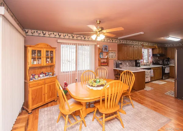 a view of a dining room with furniture window and wooden floor
