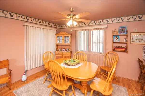 a view of a dining room with furniture a chandelier and a large window
