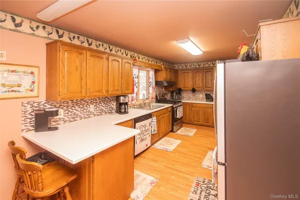 a kitchen with a sink a stove and a refrigerator