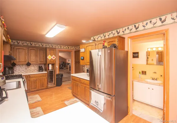 a kitchen with stainless steel appliances granite countertop a refrigerator and a stove top oven