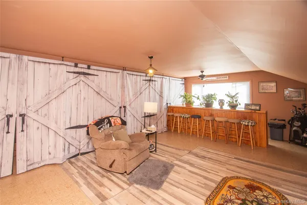 a bedroom with furniture and a wooden floor