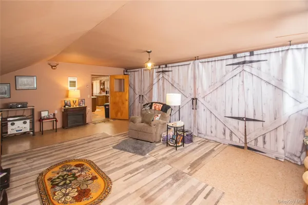 a view of a room with wooden floor and furniture