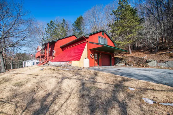 a view of a house with a yard and covered with snow