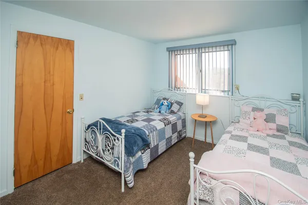 a spacious bedroom with a bed and a window