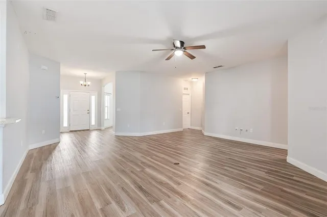 a bedroom with a large bed and a potted plant