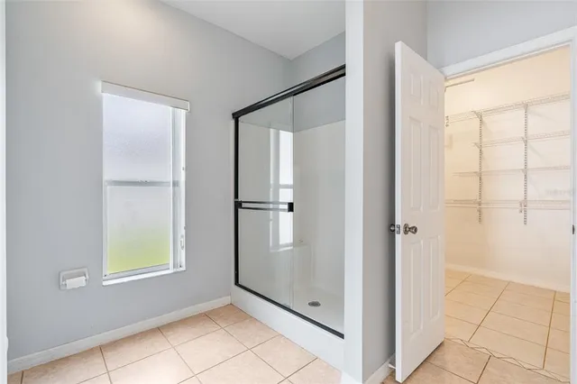 a view of empty room with wooden floor and ceiling fan