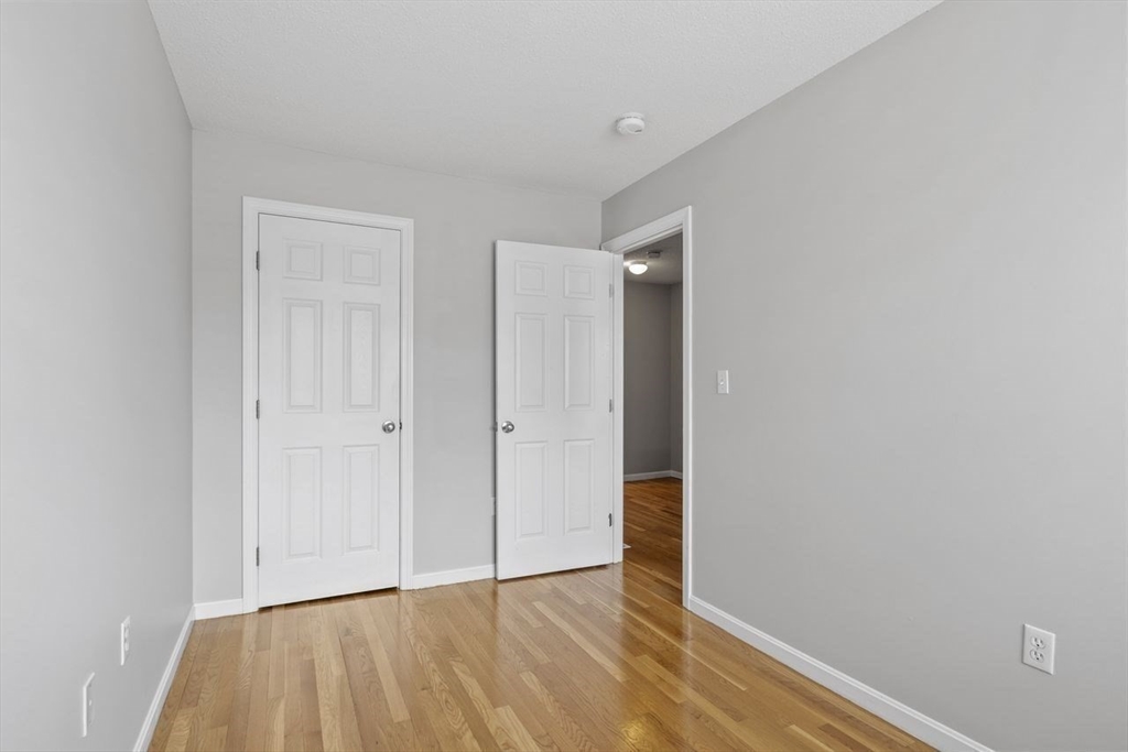 181 High Street, Unit 2 Andover, MA 01810 - Photo 14 of 32 a view of an empty room and wooden floor
