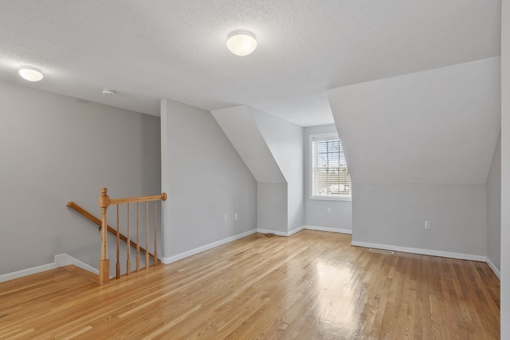 181 High Street, Unit 2 Andover, MA 01810 - Photo 17 of 32 an empty room with wooden floor and windows