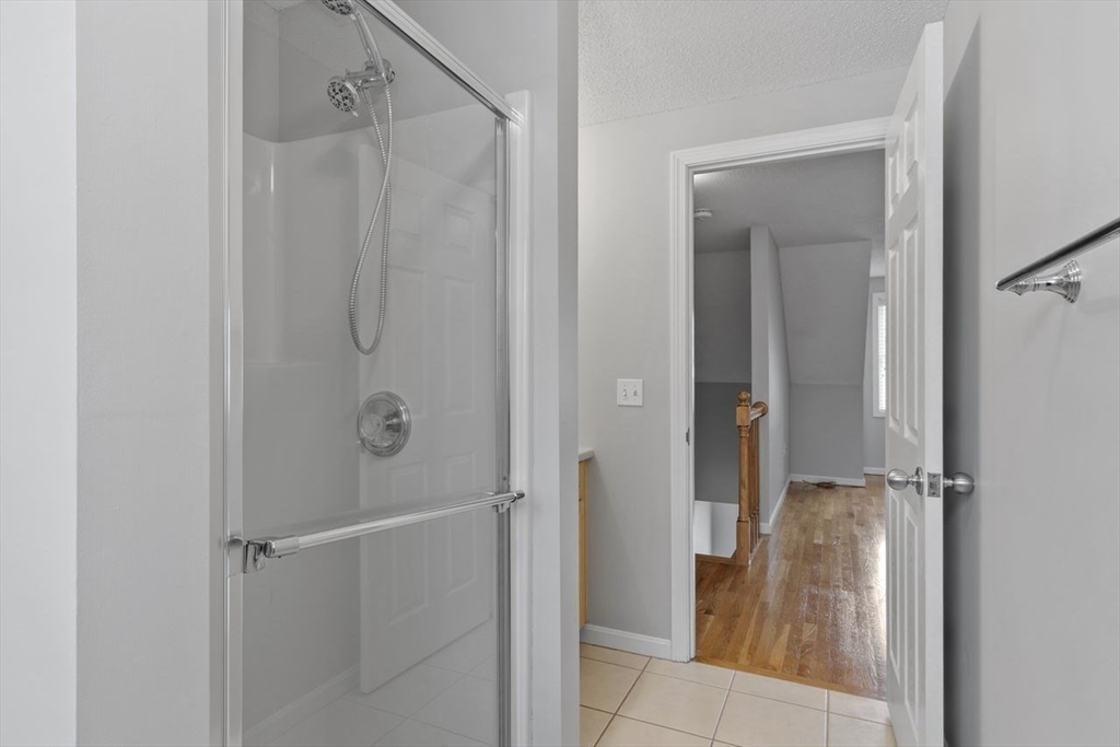 181 High Street, Unit 2 Andover, MA 01810 - Photo 20 of 32 a bathroom with a glass shower door
