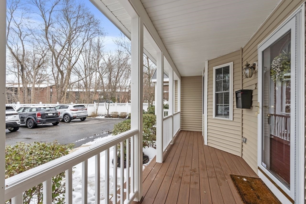 181 High Street, Unit 2 Andover, MA 01810 - Photo 27 of 32 a view of a porch with wooden floor and bench in front of house