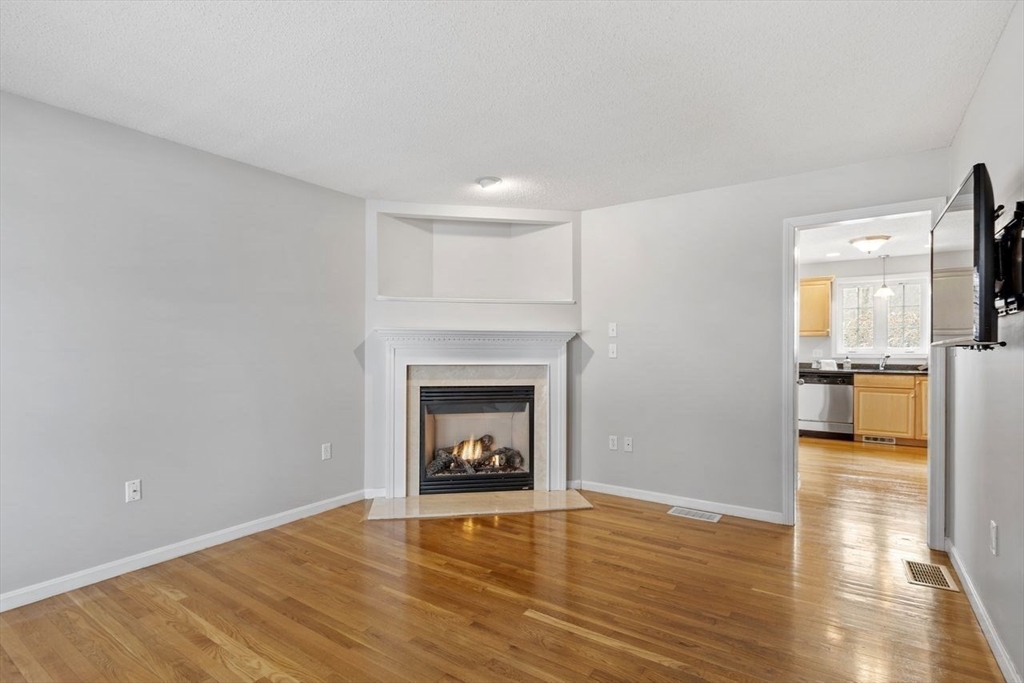 181 High Street, Unit 2 Andover, MA 01810 - Photo 7 of 32 a view of a livingroom with a fireplace