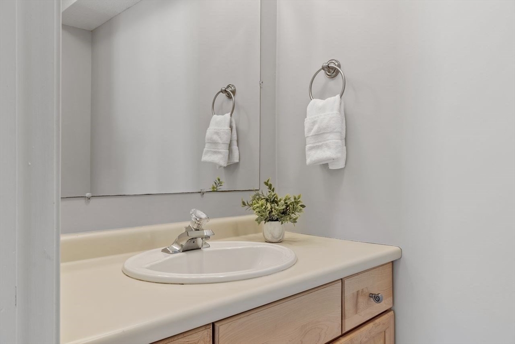181 High Street, Unit 2 Andover, MA 01810 - Photo 8 of 32 a bathroom with a sink and a mirror