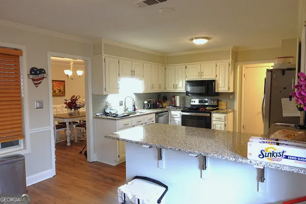 a kitchen with granite countertop stainless steel appliances and wooden cabinets