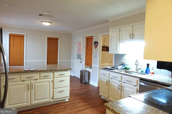 a kitchen with a sink stove and cabinets