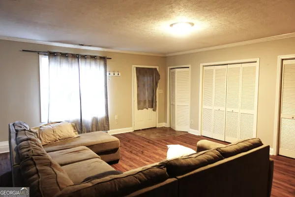 a bedroom with furniture and a window