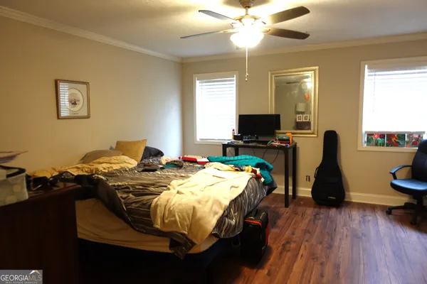 a bed sitting in a bedroom next to a window