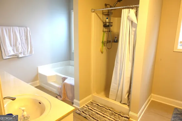 a bathroom with a tub and shower
