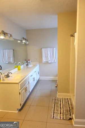 a spacious bathroom with a sink a mirror and a bathtub